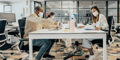 Employees in a workspace with PPE